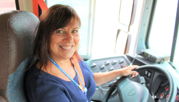 Bus driver Jeannie Bean smiles in the drivers seat