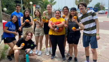 Group of students in Spain showing valencia oranges