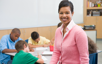 Teacher smiling in front of class
