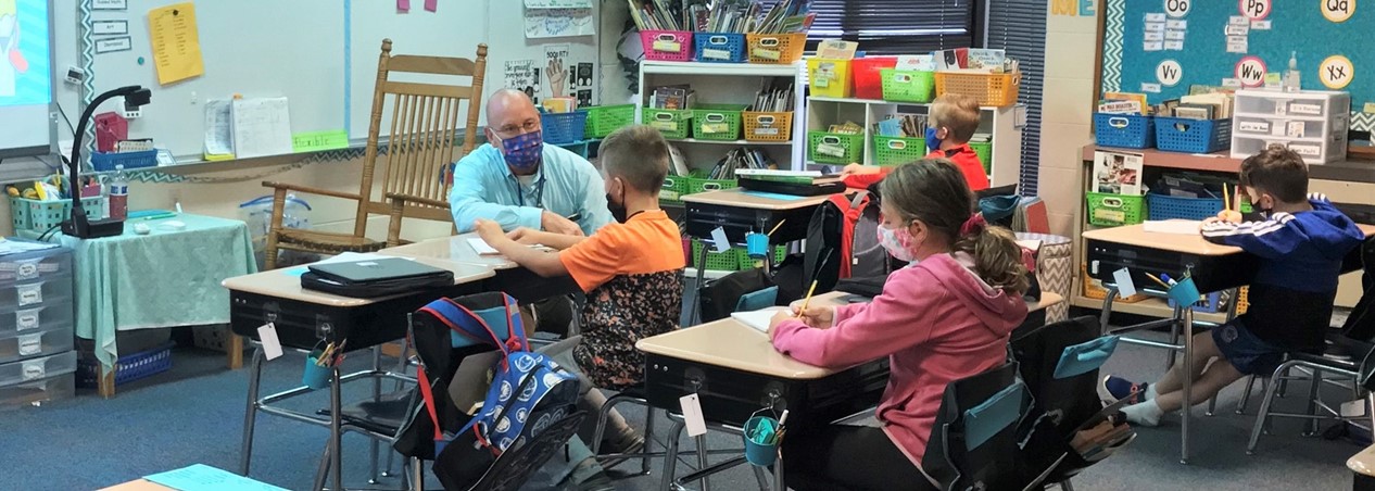 Principal Zeman visits with students