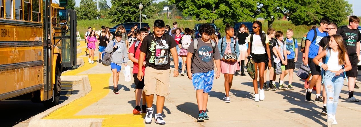 Students walk from the bus to school