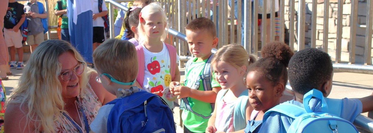 teacher welcoming students 